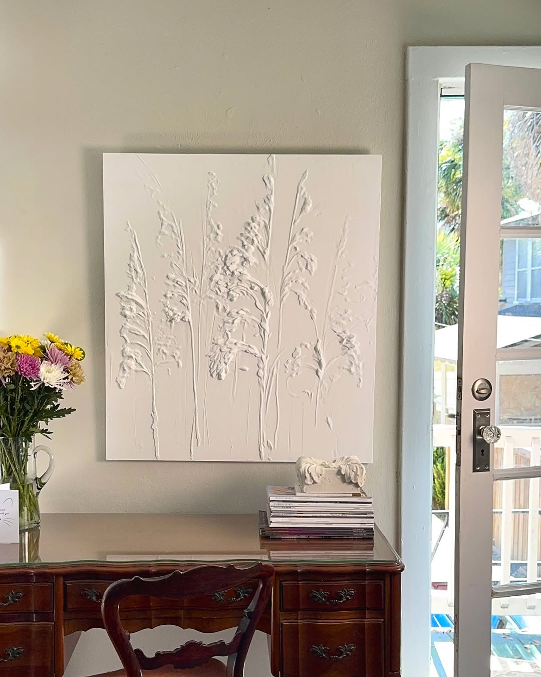 Cast plaster sea-oats relief panel hung in a Jacksonville home