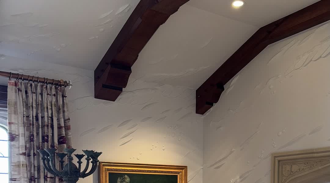 Plaster relief running across the ceiling and around the beams of a Jacksonville home